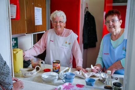 Christine (right) with fellow volunteer June serving tea at the Darling Buds of Denaby